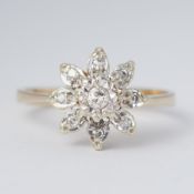 A 9ct yellow & white gold flower ring set with small round cut diamonds in an illusion style