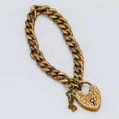A 9ct yellow gold bracelet with an engraved heart padlock and safety chain, length approx. 15cm (not