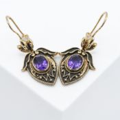 A pair of ornately designed 9ct yellow gold drop earrings set with an oval cut amethyst, length