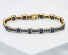 An impressive 18ct yellow gold bracelet set with twelve step cut sapphires and fifty-two square