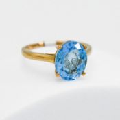 A 9ct yellow gold ring by the designer Glenn Lehhrer set with 4.39 carats of oval cut Swiss blue