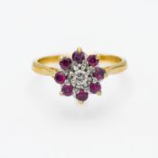 An 18ct yellow gold ruby and diamond 'Flower' design ring, size T.