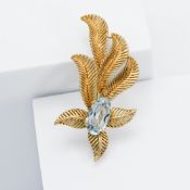 An 18ct yellow gold 'fern' design brooch set with an oval cut aquamarine, approx. 3.95 carats, the