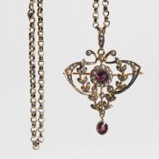 An ornate Victorian pendant with brooch fitting set with seed pearls and garnets, measuring