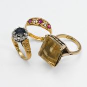 An antique 18ct yellow gold ring set with two rubies, one red stone (has been replaced) & old cut