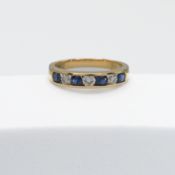 An 18ct yellow gold half eternity ring set with four round cut sapphires & three round brilliant cut