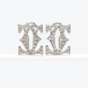 A pair of 18ct yellow & white gold earrings inspired by the Cartier double 'CC' design, set with