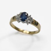 An 18ct yellow & white gold ring set with a central oval cut sapphire, approx. 0.47 carats, set with