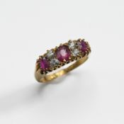 An 18ct yellow gold ring set with three oval cut rubies and interspaced with four old round cut