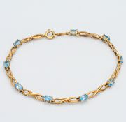 A 9ct yellow gold fancy twist Blue Topaz bracelet set with nine oval topaz's, approx weight 4.2g,