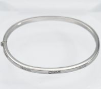 Boodles, an 18ct white gold hinged bangle set with twenty round brilliant cut diamonds, total