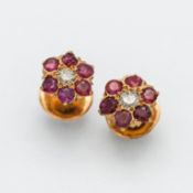 A pair of diamond and ruby flower studs on screw back fitting (not hallmarked).
