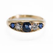 An antique 18ct yellow gold five stone ring set with three sapphires & two diamonds, the central