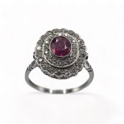 A fine cluster ring set with an oval cut ruby, approx. 0.89 carats, surrounded by two rows of