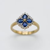 A 9ct yellow gold diamond and sapphire 'Flower' style ring, size M.