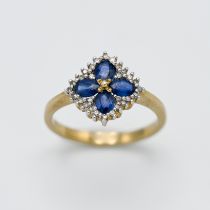 A 9ct yellow gold diamond and sapphire 'Flower' style ring, size M.