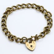 A 9ct yellow gold curb link bracelet with heart shaped lock, approx 26.2g.