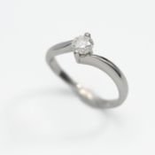 A platinum and diamond cross over ring, size M, approx 0.50ct with original purchase receipt by