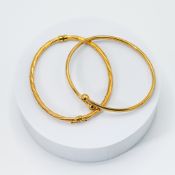 A yellow gold torque style bangle, 4.37gm and a yellow gold twisted design bangle, 3.45gm, (not