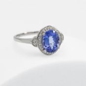 A platinum ring set with a 2.69 carat oval cut AAA Tanzanite, surrounded by 0.16 carats of diamonds,