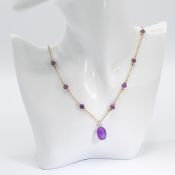 A fancy link 22" chain interspaced with faceted amethyst beads and with a yellow gold pendant set