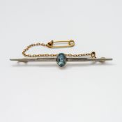 A 15ct yellow gold & platinum bar brooch set centrally with an oval cut aquamarine, approx. 0.66