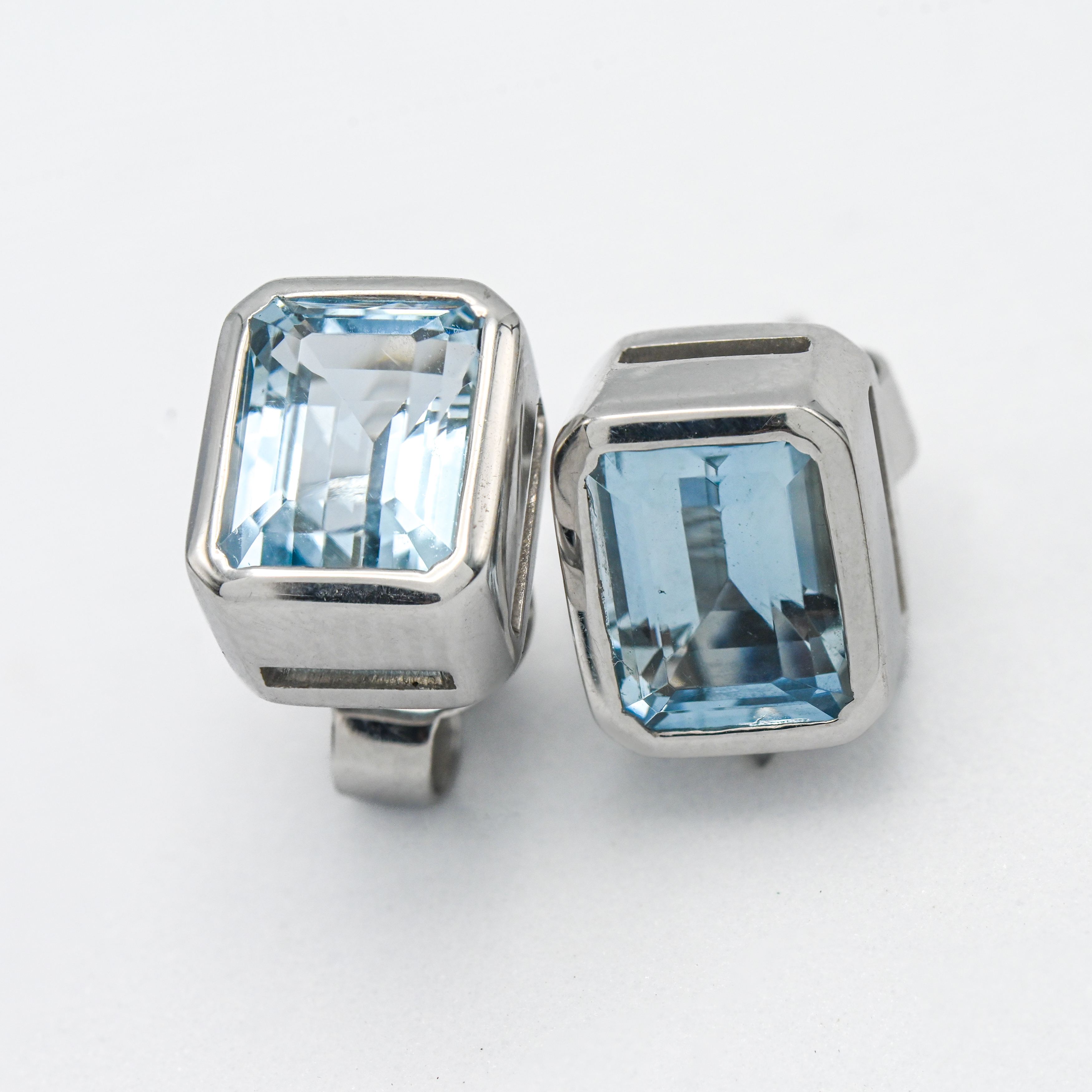 A pair of 18ct white gold emerald cut aquamarine designer stud earrings by Kojis.