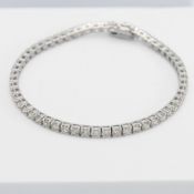 An 18ct white gold line bracelet set with round brilliant cut diamonds, total diamond weight approx.