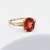 A 9ct yellow gold ring set with an oval cut 2.73 carat Tarocco Red Andesine, 2.74gm, (weighed with