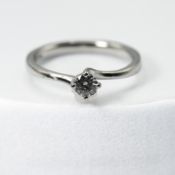 A platinum twist design solitaire ring set with approx. 0.26 carats of round brilliant cut diamonds,