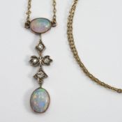A 9ct yellow gold Edwardian pendant set with two cabochon oval cut opals and four old cut