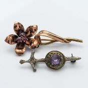 A gold and ruby? flower brooch (not hallmarked) together with another (2).