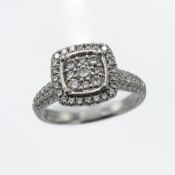 A platinum modern cluster style ring set with 0.69 carats of round brilliant cut diamonds, 7.64gm,