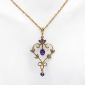 A 9ct yellow gold Art Nouveau style pendant set with oval & round cut amethyst and small round cut