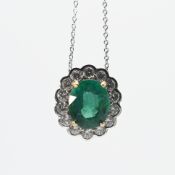 An 18ct white & yellow gold cluster style pendant set with an oval cut emerald, approx. 5.00 carats,