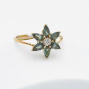 A 9ct yellow gold flower design ring set with 1.18 carats of pear shaped green Orissa