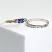 An 18ct yellow & white gold ring set with a square cut sapphire & a small round cut diamond to