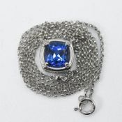 A 14ct white gold necklace with a cushion cut tanzanite, approx. 1.69 carats, with a small round