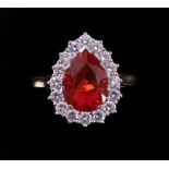An 18ct yellow & white gold pear shaped cluster ring set with a central pear shaped fire opal