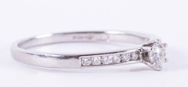 A platinum ring set with a central round brilliant cut diamond, approx. 0.15 carats - Image 2 of 2