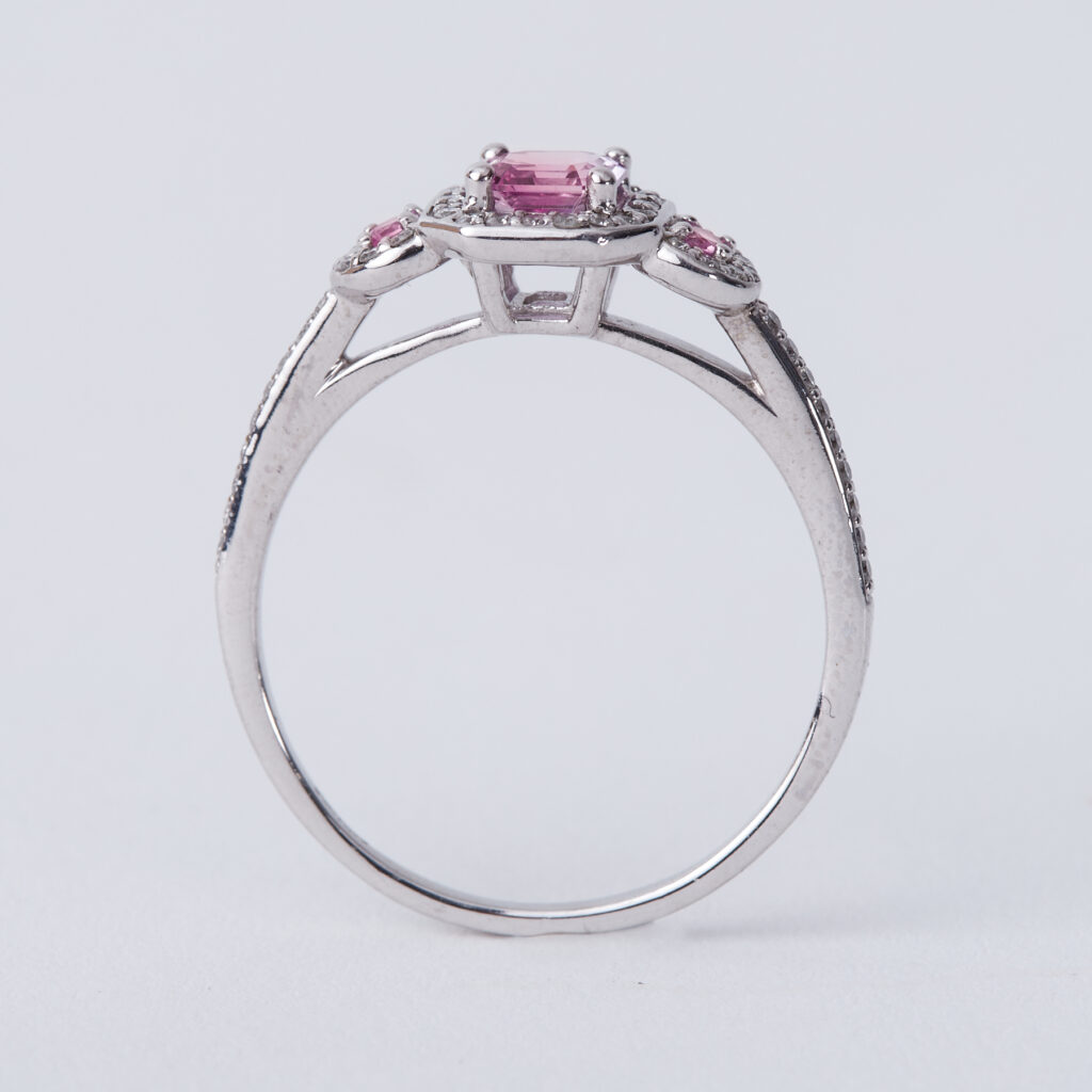 An 18ct white gold ring set with a central pink sapphire with a round pink sapphire to each side - Image 2 of 2