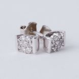 A pair of 9ct white gold flower studs set with round brilliant cut diamonds
