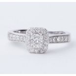 A platinum ring set with a central radiant cut diamond, approx. 0.35 carats