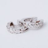 A pair of 18ct white gold half hoop style earrings set with round brilliant cut diamonds
