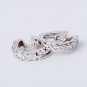 A pair of 18ct white gold half hoop style earrings set with round brilliant cut diamonds
