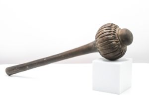 A antique Fijian Ula (Throwing Club), of dense hard wood the domed head carved with a band of lobes,
