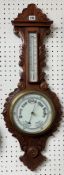 A carved oak two glass barometer with leaf pattern, 86cm x 32cm.