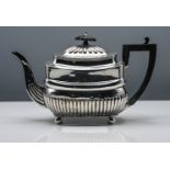 George III silver teapot, cushion shape with half fluted body, black carved finial, bun feet,