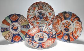 A group of four Japanese Imari plates, Meiji period and later, Each of lobed form and variously