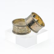 Pair of Victorian silver and chased napkin rings with original leather case, approx. 1.41oz